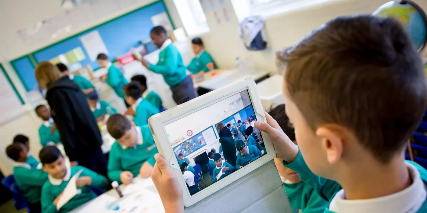 Effective strategies - boy taking a photo on iPad in the classroom
