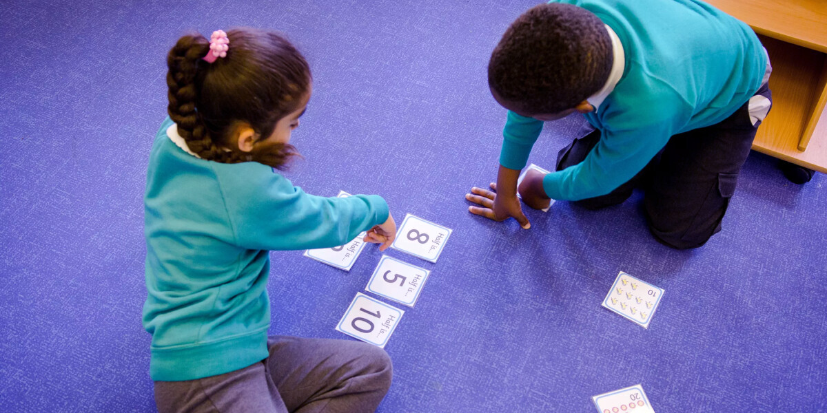 NALDIC Eventbrite Image - Two children on the carpet counting with number cards