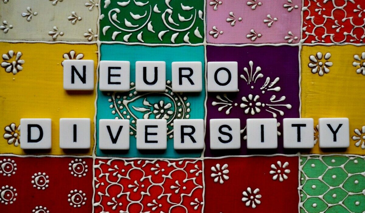 the word neuro university spelled with scrabble tiles